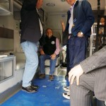 Inside the ambulance, Assembly Member Steve Colligan, seated Mayor Vern Halter, Assembly Member Randall Kowalke