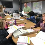 The Review Board feeding outstanding ballots into the Accu-vote machine today with the Canvass Board in support.