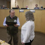 Mat-Su Mayor Reads from the Distinguished Budget award to recipient Finance Director Cheyenne Heindel